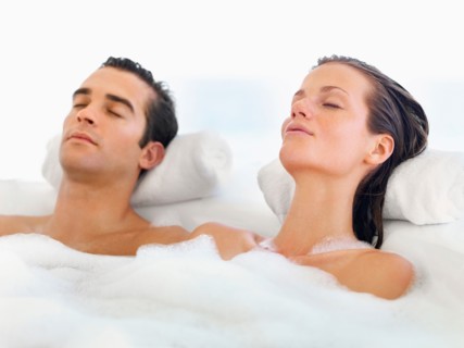 Couple relaxing in bathtub