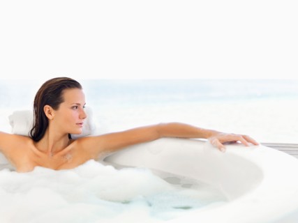 Woman relaxing in bathtub