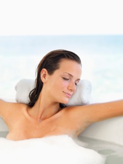 Woman relaxing in bathtub