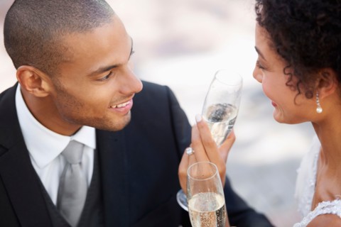 Newly wed couple drinking champagne