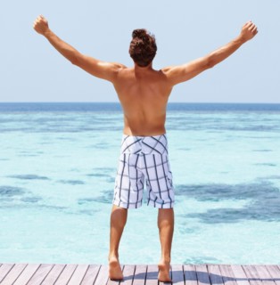 Man standing on swimming pool jetty