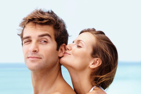 Young attractive couple enjoying summer holiday on beach