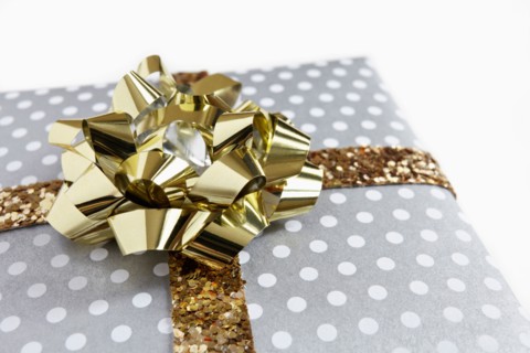 Close-up of gift with golden ribbon