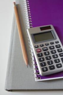 Calculator, textbook, pencil and notebook, studio shot