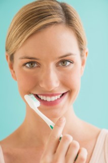 Portrait of woman brushing teeth.