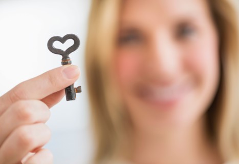 Woman holding heart-shaped key.