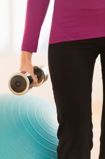 Woman holding dumbbell.