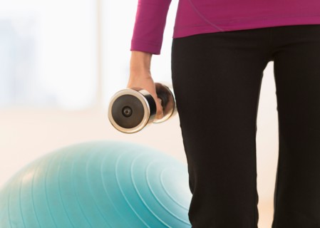 Woman holding dumbbell.