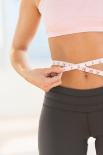 Woman measuring waist.