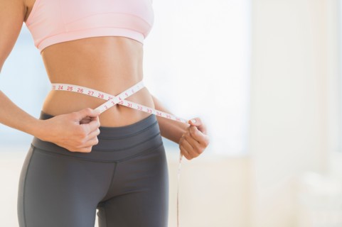Woman measuring waist.