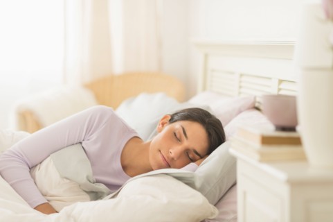 Woman sleeping in bed.