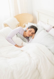 Woman sleeping in bed.