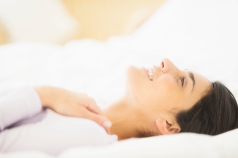 Woman lying in bed.
