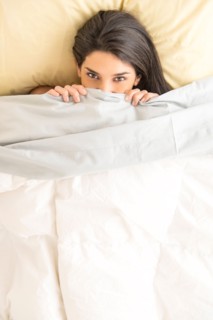 Woman lying in bed.