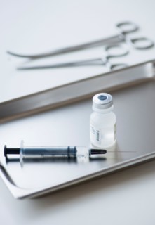 Close up of syringe and medication, studio shot.