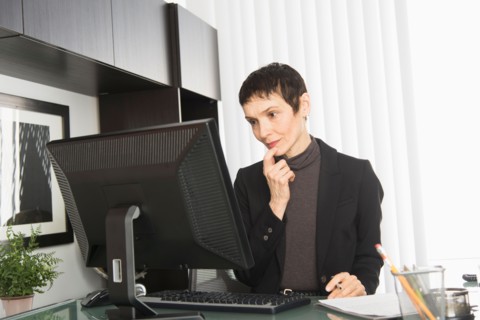 Businesswoman working at desk.