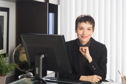 Portrait of businesswoman at desk.