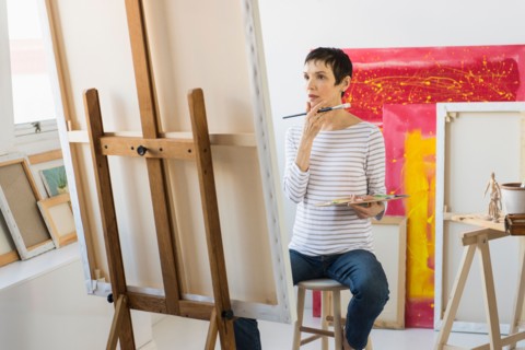 Female artist painting in her studio.
