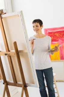 Female artist painting in her studio.