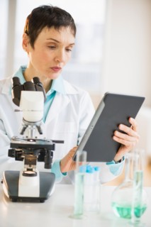 Woman using digital tablet in laboratory.
