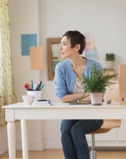 Woman sitting in home office.
