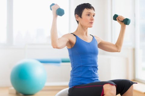 Mature woman exercising in gym.