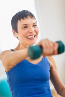 Mature woman exercising in gym.