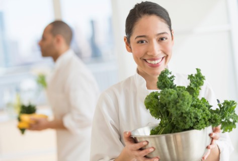 Couple during preparations in kitchen of their own restaurant.