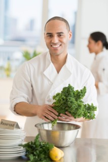 Couple during preparations in kitchen of their own restaurant.