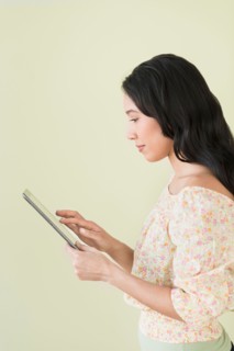 Young woman using digital tablet.