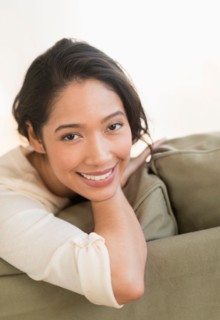 Portrait of young woman sitting on couch.