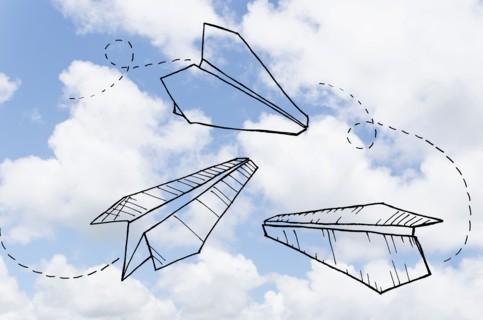 Paperplanes drawn on cloudy sky