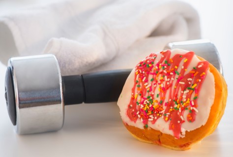 Studio Shot of jelly doughnut and hand weight