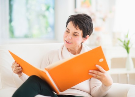 Portrait of mature woman looking at photo album