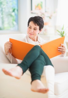 Portrait of mature woman looking at photo album