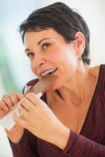 Portrait of mature woman eating chocolate