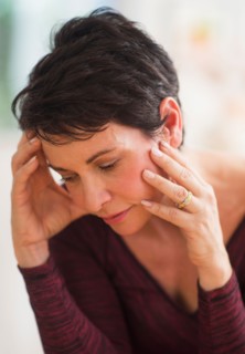 Portrait of mature woman with hands on head