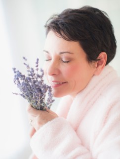 Portrait of mature woman smelling flowers