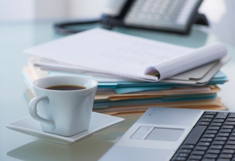 Close-up of coffee, paper material , laptop and telephone