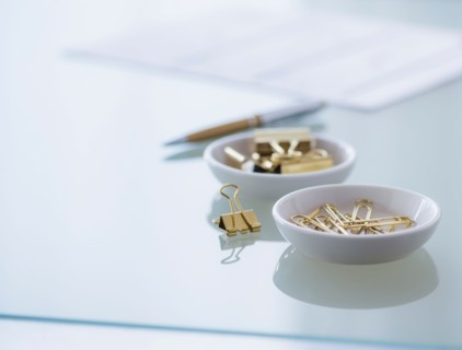 Close-up of paper clip and binder clip