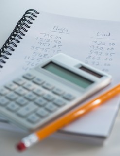 Studio Shot of calculator pen and spiral-bound notebook