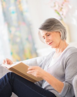 Portrait of woman reading on sofa