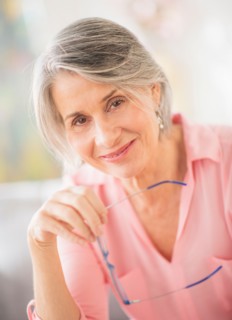 Portrait of woman holding glasses