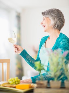 Portrait of woman raising wine glass