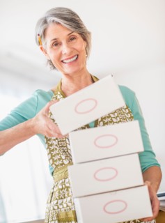 Portrait of woman carrying boxes