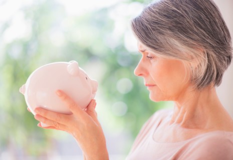 Portrait of woman holding piggy bank