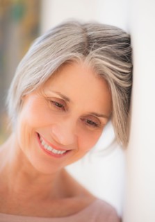 Portrait of relaxed woman leaning against wall