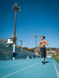 Woman running at sports field