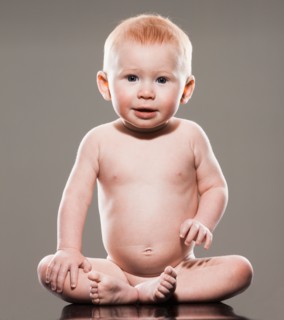 Studio shot of naked baby boy (18-23 months) sitting