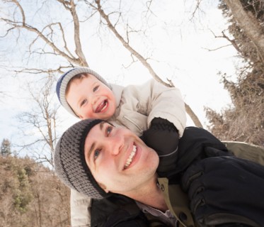 Young man carrying his son (12-17 months) on shoulders